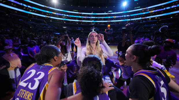 The Los Angeles Sparks huddle around Cameron Brink at Crypto.com Arena.