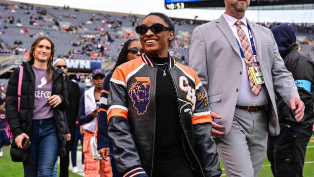 Star gymnast Simone Biles looks on before the game at Soldier Field.