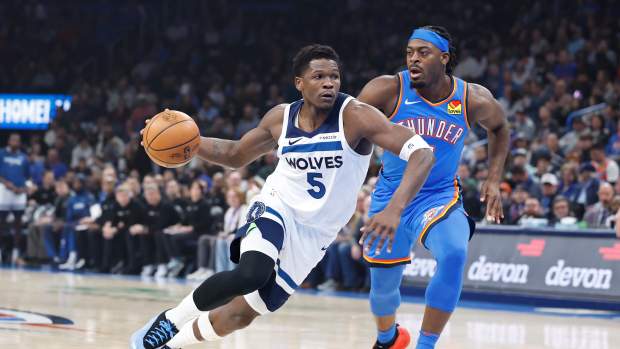 Dec 31, 2024; Oklahoma City, Oklahoma, USA; Minnesota Timberwolves guard Anthony Edwards (5) drives to the basket beside Oklahoma City Thunder guard Luguentz Dort (5) during the first quarter at Paycom Center.