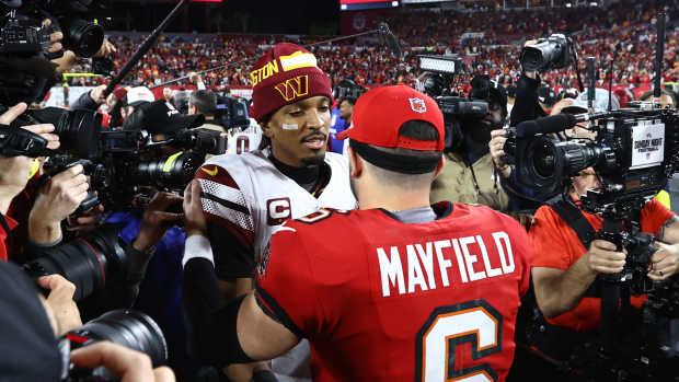 Washington Commanders quarterback Jayden Daniels (5) greets Tampa Bay Buccaneers quarterback Baker Mayfield (6).