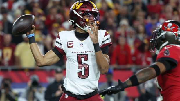 Washington Commanders quarterback Jayden Daniels throws during the second quarter at Raymond James Stadium.