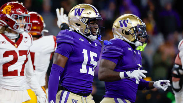 Nov 2, 2024; Seattle, Washington, USA; Washington Huskies wide receiver Keith Reynolds (15) celebrates after rushing for a touchdown against the USC Trojans during the fourth quarter at Alaska Airlines Field at Husky Stadium.