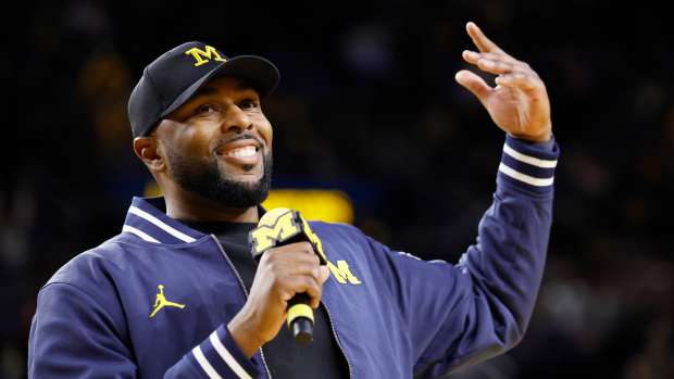 Sherrone Moore speaks at the Michigan vs. Northwestern basketball game on January 19.