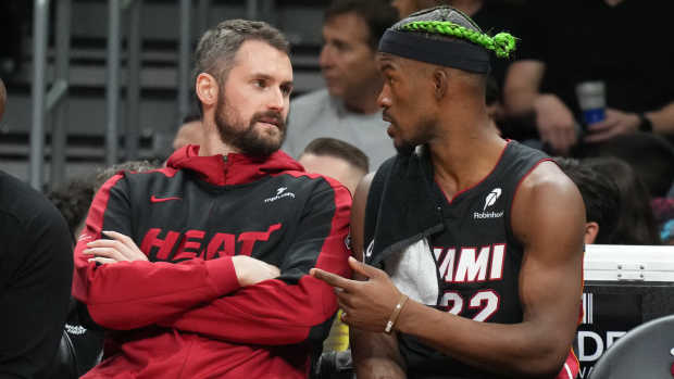 Miami Heat forward Jimmy Butler (right) talks with forward Kevin Love (left).