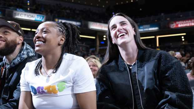 Indiana Fever guards Caitlin Clark (right) and Kelsey Mitchell (left) at an Indiana Pacers game at Gainbridge Fieldhouse.