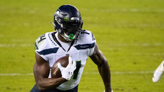 Seahawks' D.K. Metcalf (14) carries the ball against the Eagles.