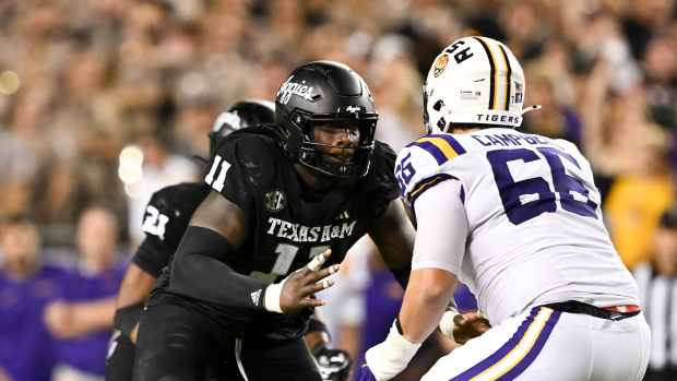 Texas A&M Aggies defensive lineman Nic Scourton (11) defends in coverage against LSU Tigers offensive tackle Will Campbell.