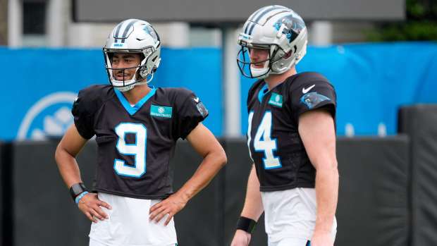 Carolina Panthers quarterback Bryce Young (9) and quarterback Andy Dalton (14) talk during training camp at Carolina Panthers Practice Fields.