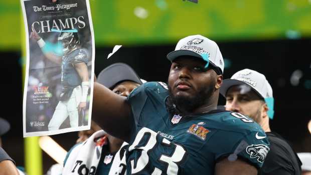 Philadelphia Eagles defensive tackle Milton Williams (93) celebrates on the podium after defeating the Kansas City Chiefs in Super Bowl LIX at Ceasars Superdome.