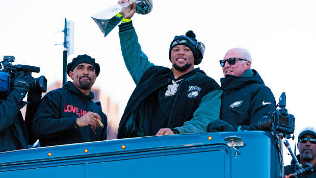 Philadelphia Eagles running back Saquon Barkley (26) lifts the Lombardi Trophy during the Super Bowl LIX championship parade.