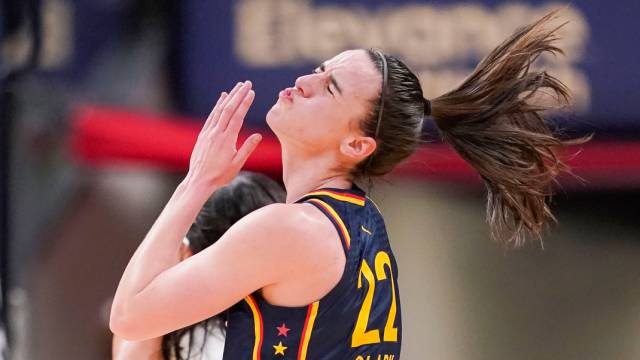 Indiana Fever guard Caitlin Clark (22) throws her head back after getting hit in the face Thursday, May 9, 2024, during the preseason game against the Atlanta Dream.