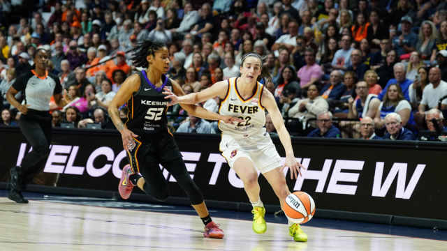 Indiana Fever guard Caitlin Clark (22) returns the ball vs. Connecticut Sun guard Tyasha Harris (52) in the first quarter at Mohegan Sun Arena. 