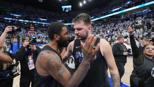 Dallas Mavericks guard Kyrie Irving (11) and guard Luka Doncic (77) celebrate after defeating the Minnesota Timberwolves in game two of the western conference finals for the 2024 NBA playoffs at Target Center.