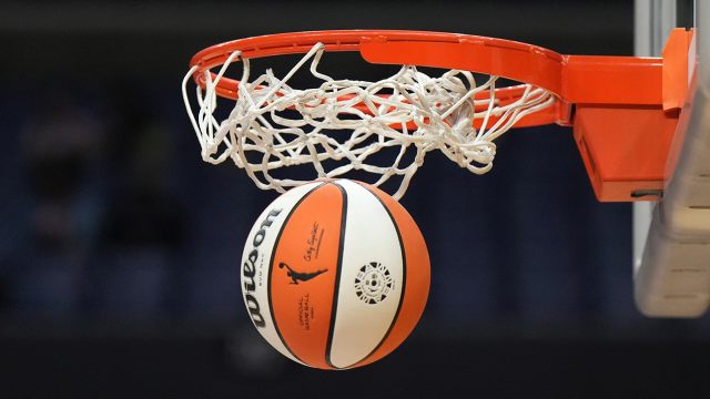 A WNBA basketball goes through the basket during the Aces-Sparks game in Los Angeles on May 25, 2023.