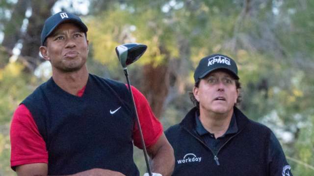 November 23, 2018; Las Vegas, NV, USA; Tiger Woods (left) hits his tee shot in front of Phil Mickelson (right) on the 16th hole during The Match: Tiger vs Phil golf match at Shadow Creek Golf Course. Mandatory Credit: Kyle Terada-USA TODAY Sports  