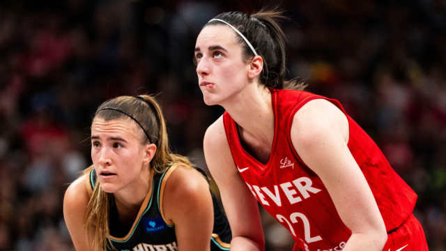 New York Liberty guard Sabrina Ionescu and Indiana Fever guard Caitlin Clark watch a free throw during their game in Indianapolis on July 6, 2024. The Fever beat the Liberty, 83-78.