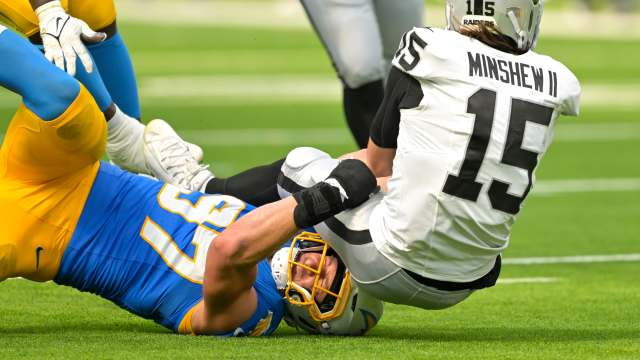 Sep 8, 2024; Inglewood, California, USA; Las Vegas Raiders quarterback Gardner Minshew (15) is sacked by Los Angeles Chargers linebacker Joey Bosa (97) in the second half at SoFi Stadium.