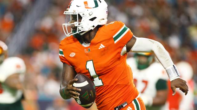 Miami Hurricanes quarterback Cam Ward (1) runs with the football for a touchdown against the Florida A&M Rattlers.