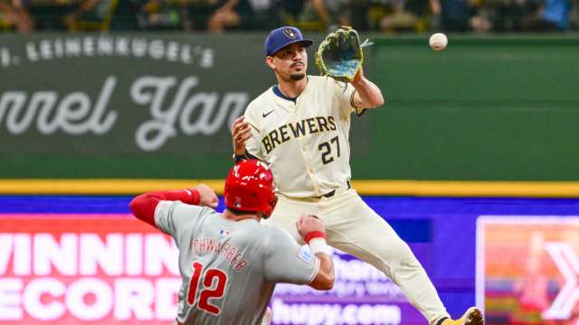 Sep 18, 2024; Milwaukee, Wisconsin, USA; Milwaukee Brewers shortstop Willy Adames (27) forces out Philadelphia Phillies designated hitter Kyle Schwarber (12) in the eighth inning at American Family Field.