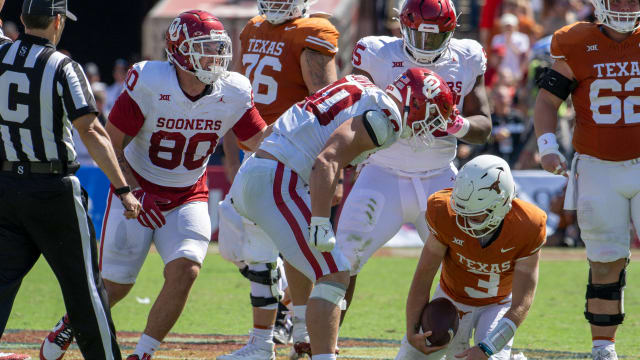 Oct 7, 2023; Dallas, Texas, USA; Oklahoma Sooners defensive lineman Ethan Downs (40) stands over Texas Longhorns quarterback Quinn Ewers (3) after Ewers is sacked for a loss during the second half at the Cotton Bowl. Mandatory Credit: Jerome Miron-USA TODAY Sports