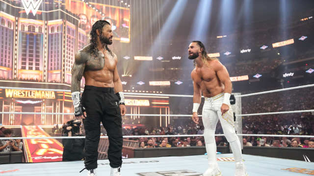 Roman Reigns facing off with Seth Rollins wearing the Concord 11 boots