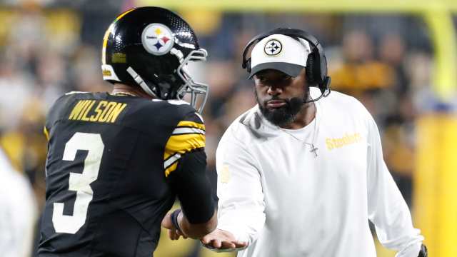 Pittsburgh Steelers coach Mike Tomlin congratulates quarterback Russell Wilson at Acrisure Stadium.