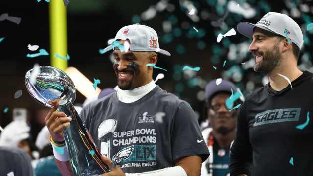 Philadelphia Eagles quarterback Jalen Hurts holds the Vince Lombardi Trophy as head coach Nick Sirianni looks on after defeating the Kansas City Chiefs in Super Bowl LIX at the Superdome in New Orleans.