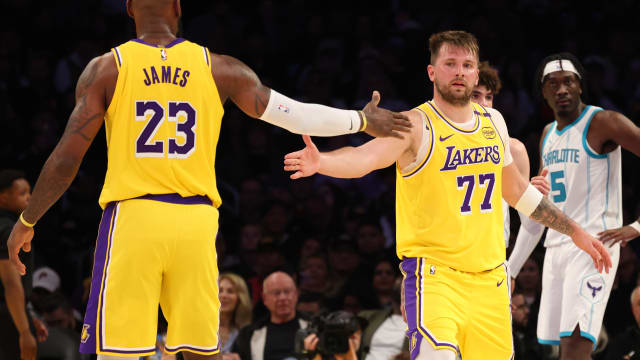 Feb 19, 2025; Los Angeles, California, USA; Los Angeles Lakers forward LeBron James (23) and guard Luka Doncic (77) celebrate after a play during the third quarter against the Charlotte Hornets at Crypto.com Arena. Mandatory Credit: Jason Parkhurst-Imagn Images
