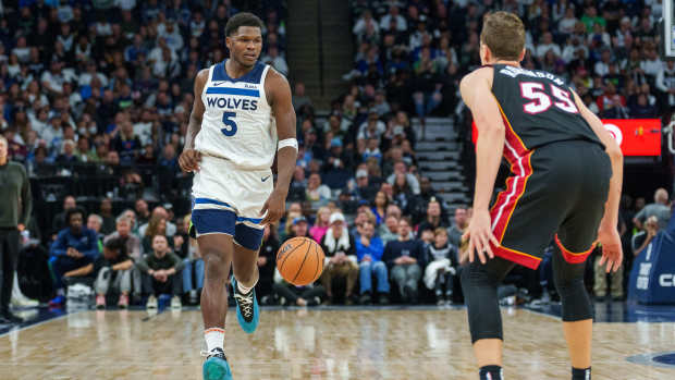 Minnesota Timberwolves guard Anthony Edwards (5) is guarded by Miami Heat forward Duncan Robinson (55).