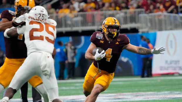 Cam Skattebo runs at the Peach Bowl.