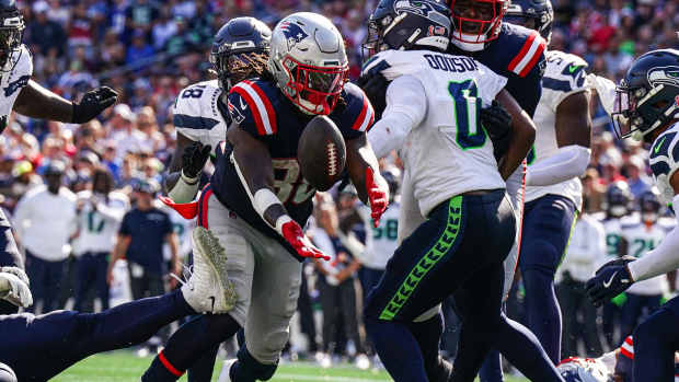 Sep 15, 2024; Foxborough, Massachusetts, USA; New England Patriots running back Rhamondre Stevenson (38) looses contriol of the ball against Seattle Seahawks linebacker Tyrel Dodson (0) in the second half at Gillette Stadium. 