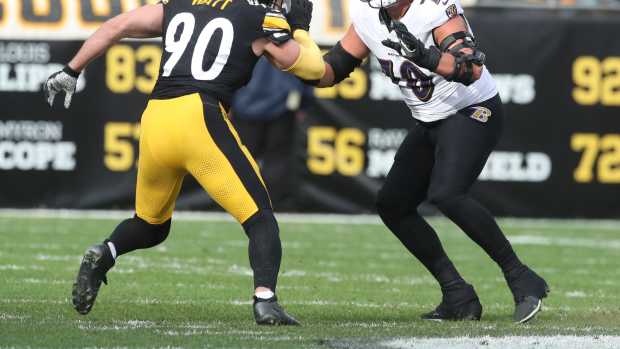 Nov 17, 2024; Pittsburgh, Pennsylvania, USA; Baltimore Ravens offensive tackle Roger Rosengarten (70) blocks at the line of scrimmage against Pittsburgh Steelers linebacker T.J. Watt (90) during the second quarter at Acrisure Stadium.