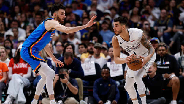 Nuggets forward Michael Porter Jr. (1) controls the ball as Thunder forward Chet Holmgren (7) guards.