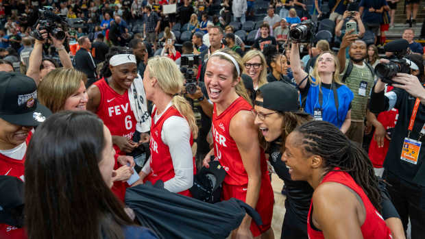 The Indiana Fever celebrate after defeating the Minnesota Lynx in the Commissioner's Cup Championship. 