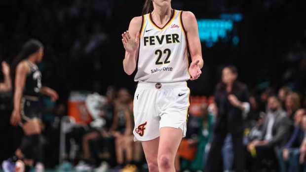 Indiana Fever guard Caitlin Clark (22) applauds while looking at the scoreboard in the third quarter against the New York Liberty at Barclays Center. 