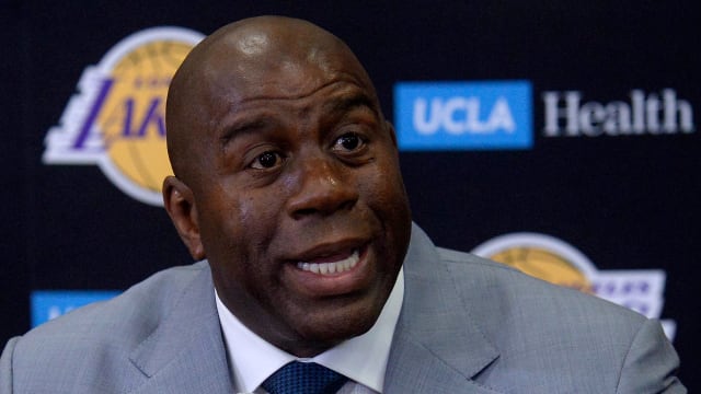 Former Los Angeles Lakers president of basketball operations Magic Johnson speaks to the media.
