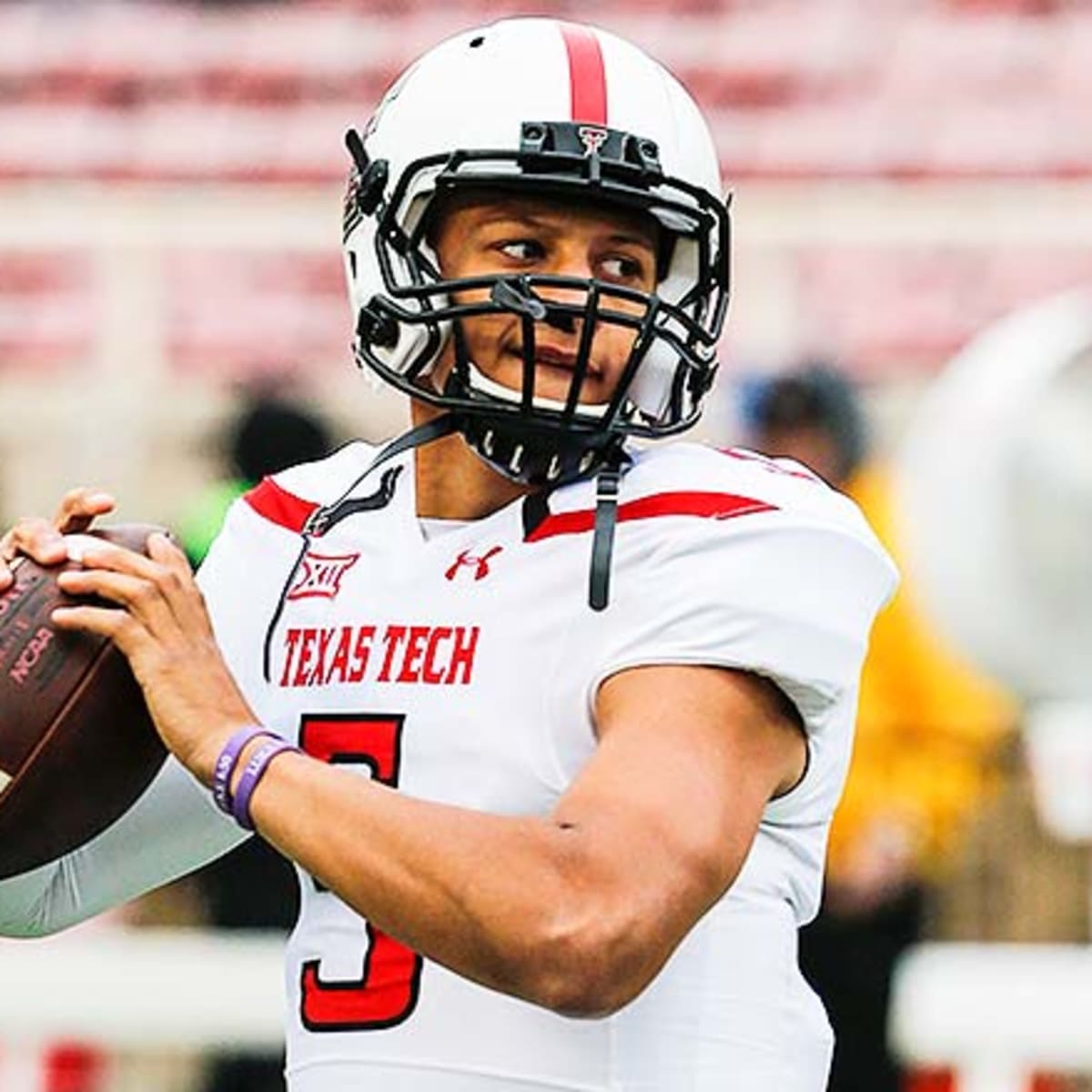 Patrick Mahomes Texas Tech Red Raiders Unsigned White Jersey Signaling with Fists to Helmet Photograph