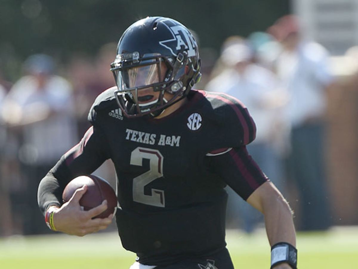 Johnny Manziel takes refuge under table at card signings