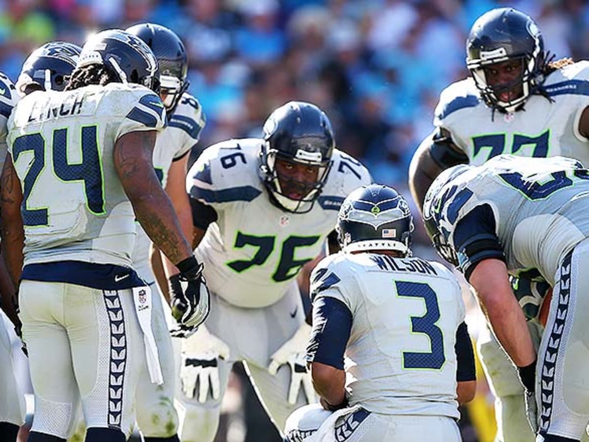 Seattle Seahawks' running back Marshawn Lynch runs past St. Louis Rams'  linebacker James Laurinaitis for a 12-yard gain in the first quarter of the  NFL's Western Division Championship game on Sunday January