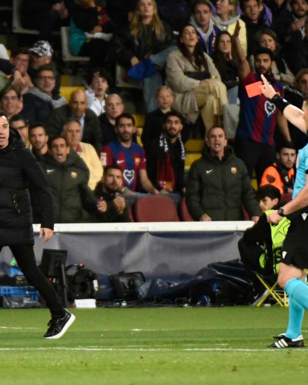 Referee Istvan Kovacs pictured showing a red card to Barcelona boss Xavi Hernandez during a UEFA Champions League game against PSG in April 2024