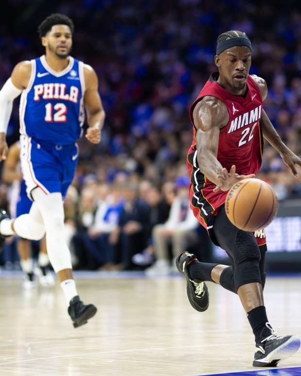 Apr 17, 2024; Philadelphia, Pennsylvania, USA; Miami Heat forward Jimmy Butler (22) dribbles the ball past Philadelphia 76ers forward Tobias Harris (12) during the first quarter of a play-in game of the 2024 NBA playoffs at Wells Fargo Center.