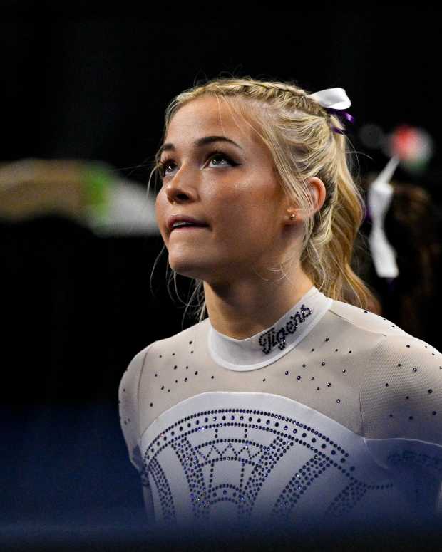 Apr 20, 2024; Fort Worth, TX, USA; LSU Tigers gymnast Olivia Dunne watches as LSU Tigers gymnast Haleigh Bryant performs on uneven bars during the 2024 Womens National Gymnastics Championship at Dickies Arena.