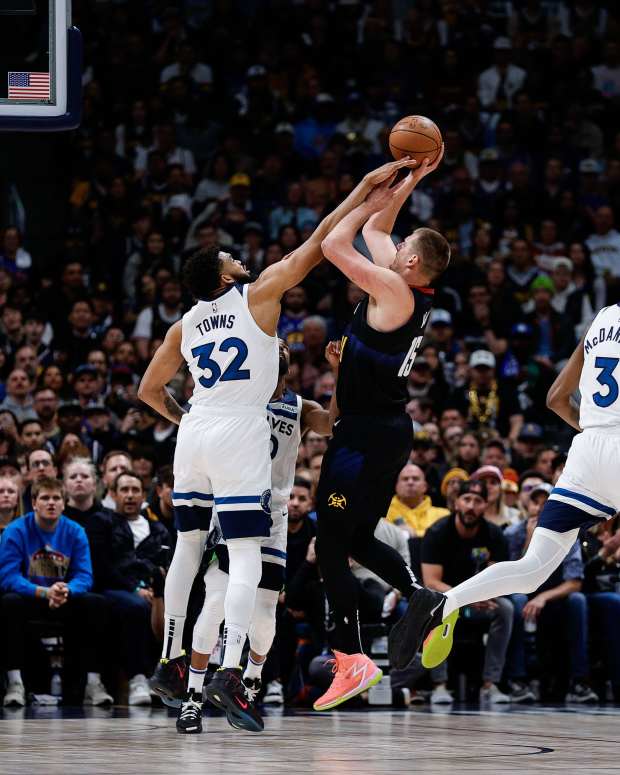 May 6, 2024; Denver, Colorado, USA; Denver Nuggets center Nikola Jokic (15) attempts a shot as Minnesota Timberwolves center Karl-Anthony Towns (32) defends in the first quarter during game two of the second round for the 2024 NBA playoffs at Ball Arena.