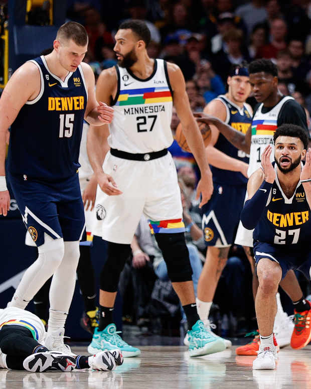 Apr 19, 2023; Denver, Colorado, USA; Denver Nuggets guard Jamal Murray (27) reacts after a play with Minnesota Timberwolves guard Mike Conley (10) as center Nikola Jokic (15) and center Rudy Gobert (27) look on in the fourth quarter during game two of the 2023 NBA Playoffs at Ball Arena.