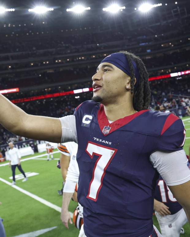 Jan 13, 2024; Houston, Texas, USA; Houston Texans quarterback C.J. Stroud (7) holds a phone on the field after a 2024 AFC wild card game against the Cleveland Browns at NRG Stadium.