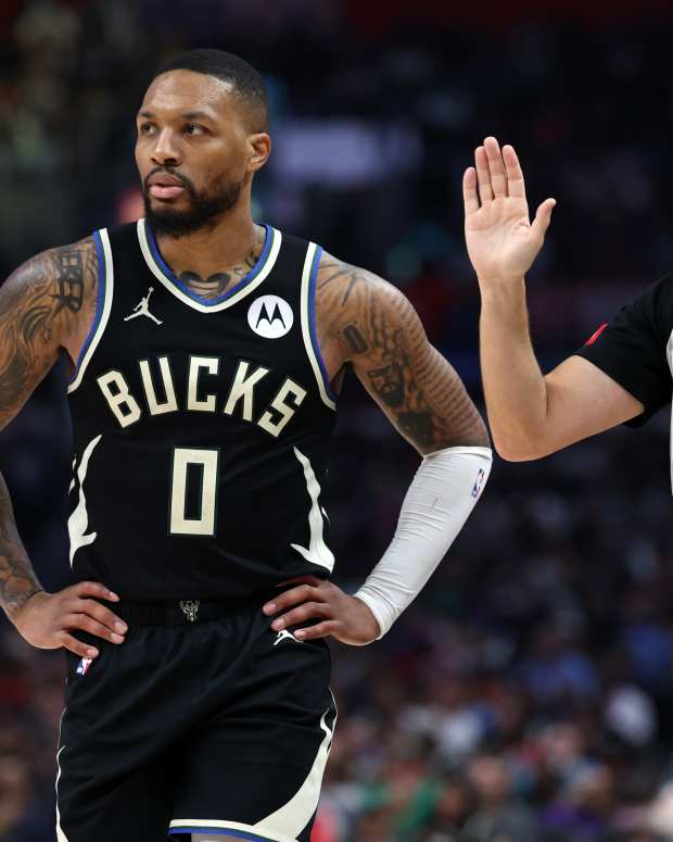 Mar 10, 2024; Los Angeles, California, USA; Milwaukee Bucks guard Damian Lillard (0) stands next to a referee Scott Foster (48) during the third quarter against the Los Angeles Clippers at Crypto.com Arena.