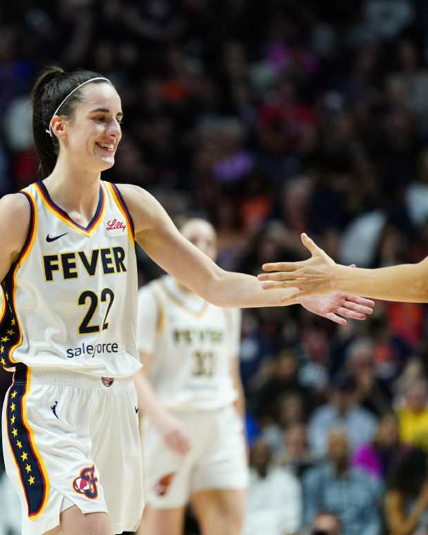 Indiana Fever guard Caitlin Clark (22) reacts with guard Kristy Wallace (3) during a break in the action against the Connecticut Sun in the second half at Mohegan Sun Arena.
