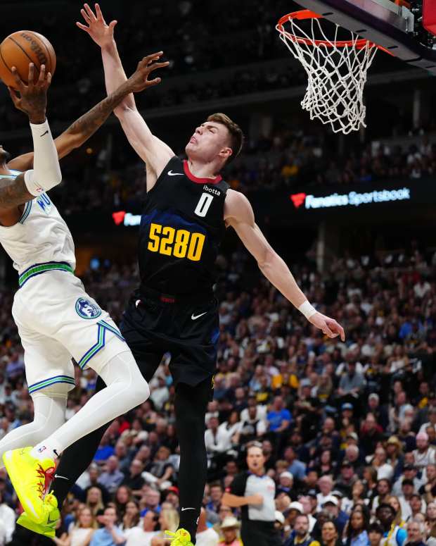 May 19, 2024; Denver, Colorado, USA; Minnesota Timberwolves forward Jaden McDaniels (3) shoots at Denver Nuggets guard Christian Braun (0) in the first half in game seven of the second round for the 2024 NBA playoffs at Ball Arena.