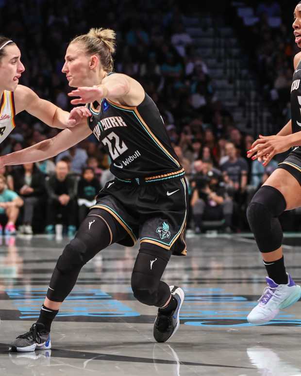 May 18, 2024; Brooklyn, New York, USA; Indiana Fever guard Caitlin Clark (22) looks to drive past New York Liberty guard Courtney Vandersloot (22) in the first quarter at Barclays Center.