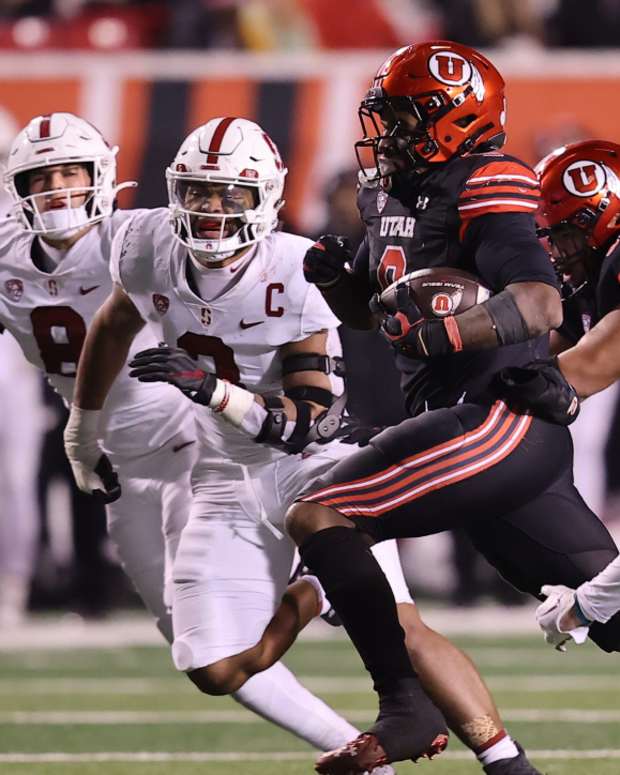 Utah Utes running back Tavion Thomas (9) runs the ball against Stanford Cardinal safety Scotty Edwards (37) in the fourth quarter of a 2022 game at Rice-Eccles Stadium.
